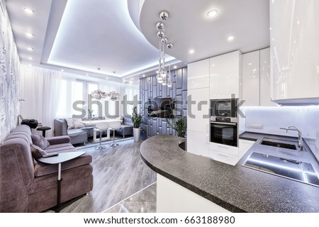 Modern design interior room with white gloss kitchen in a luxury apartment in gray and white tones.