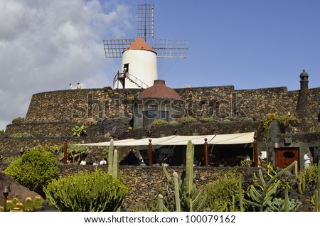 GUATIZA, SPAIN- JANUARY 19: The Jardin de Cactus with old windmill and restaurant, the garden is designed by Cesar Manrique the most importand artist in Lanzarote on January 19, 2012 in Guatiza, Spain