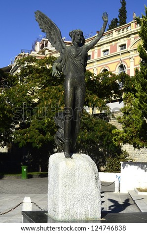 KAVALA, GREECE - SEPTEMBER 23: Statue of Godess Nike in the Iroon public garden was made by sculptor John Parmakelis, in background the Megali Leschi building, on September 23, 2012 in Kavala, Greece