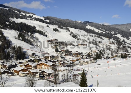 SAALBACH, AUSTRIA - FEBRUARY 18: Unidentified people in ski resort Saalbach-Hinterglemm enjoy winter sport activities on a sunny day in snowy Glemm-valley, on February 18, 2013 in Saalbach, Austria