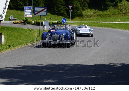LUNZ, AUSTRIA - JULY 19: Cars on special stage by International Ennstal Classic 2013, a yearly tournament through Austria for vintage cars on July 19, 2013, in Lunz am See, Austria