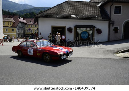 LUNZ, AUSTRIA - JULY 19: Unidentified spectators and Ferrari 365 on special stage by International Ennstal Classic 2013, a yearly tournament for vintage cars on July 19, 2013, in Lunz am See, Austria