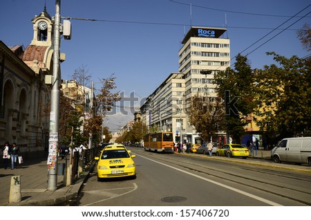 SOFIA, BULGARIA - SEPTEMBER 28: Unidentified people, public tram and cars on Knyaginya Maria Louise Boulevard, left the Central Sofia Market building, on September 28, 2013 in Sofia, Bulgaria