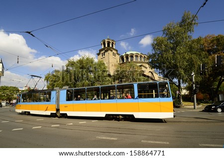 SOFIA, BULGARIA - SEPTEMBER 28: Unidentified people in public tram in front of cathedral Sveta Nedelja- trams only used in Sofia , on September 28, 2013 in Sofia, Bulgaria