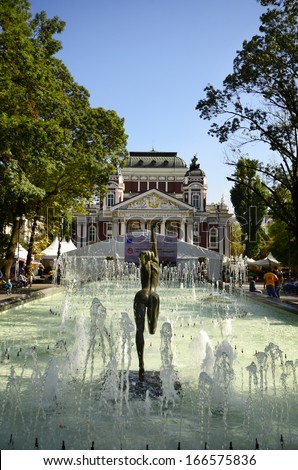 SOFIA, BULGARIA - SEPTEMBER 28: Unidentified people relaxing around the pool with small fountains and sculpture in the city garden in front of the Theater Iwan Vazov, on Septembet 28, 2013 In Sofia