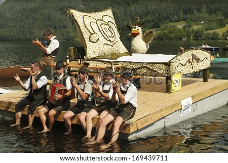 BAD AUSSEE, AUSTRIA - MAY 30: Unidentified men in traditional dress on platform with bed decorated with blossoms of daffodils, a yearly event in Salzkammergut, on May 30, 2005 in Bad Aussee, Austria