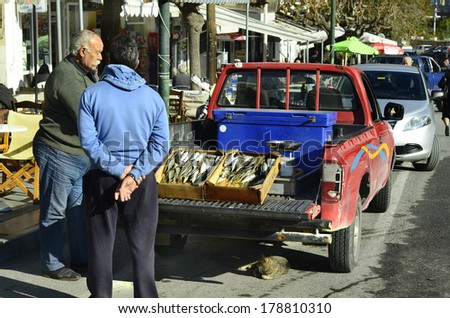 NEAPOLI, GREECE - DECEMBER 23: Unidentified traveling salesman with fish for sale on car, a traditional kind of sale in parts of Crete, on December 23, 2013 in Neapoli, Greece