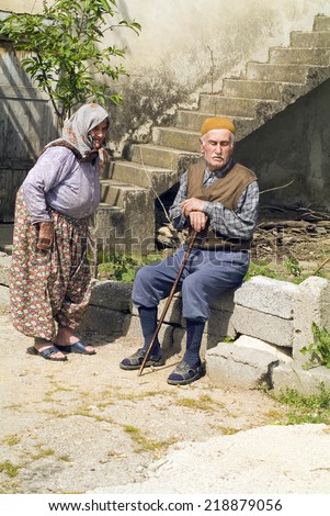 BEREKET, TURKEY - APRIL 10: Unidentified elder couple in traditional rural dress enjoy a rest in the spring sun in a small village near Antalya, on April 10, in Bereket, Turkey