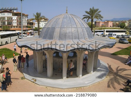 MANAVGAT, TURKEY - APRIL 10: Unidentified tourists on the building for ritual bath of the big mosque of Manavgat aka Kueliye mosque, on April 10, 2009, in Manavgat, Turkey