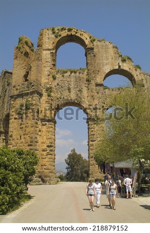 BELKIS, TURKEY, APRIL 12: Unidentified tourists by sightseeing on ancient aqueduct of Aspendos, on April 12, 2009, in Belkis, Turkey