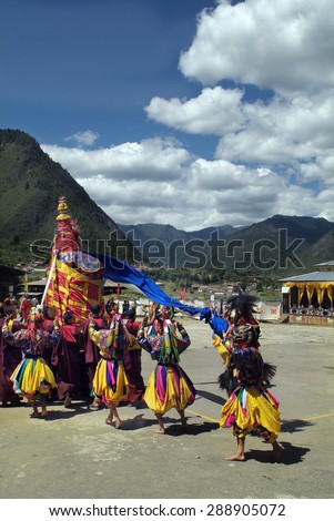 HAA, BHUTAN - SEPTEMBER 21: Unidentified people and masked dancers by traditional festivity named Tshechu perform sacred dance of the Rakshas aka Raksha Mangcham, on September 21, 2007 in Haa, Bhutan