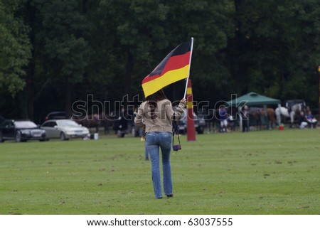 EBREICHSDORF, AUSTRIA - SEPTEMBER 10: unknown German Fan with Flag at Polo European Championship match on September 10, 2010 in Ebreichsdorf, Austria
