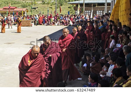 HAA, BHUTAN - SEPTEMBER 21: unknown spectators, monks and dancers with masks at the religous festival named Tshechu in the White Temple (Karpho Lhakhang) on September 21, 2007 in Haa, Bhutan