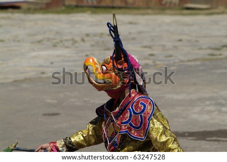 HAA, BHUTAN - SEPTEMBER 21: unknown spectators and dancers with masks at the religous festival named Tshechu in the White Temple (Karpho Lhakhang) on September 21, 2007 in Haa, Bhutan