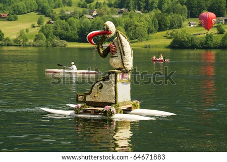 BAD AUSSEE, AUSTRIA - MAY 30: flower made figure and unidentified spectators at Narcissus Festival on May 30, 2005 on the Grundlsee-Lake in Bad Aussee, Styria, Austria