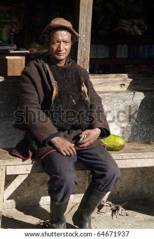 TRASHIGANG BHUTAN - SEPTEMBER 29: unidentified peasant from Village Merak on the border to India in traditional clothes (yak wool vest)  on September 29 in Galing, Trashigang, Bhutan