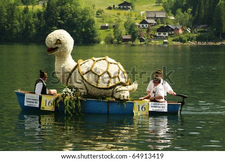 BAD AUSSEE, AUSTRIA, MAY 30, unidentiefied people on boats with flover figures by yearly Festival of Narcissus on the Grundlsee-Lake on May 30, 2005 in Bad Aussee, Styria, Austria