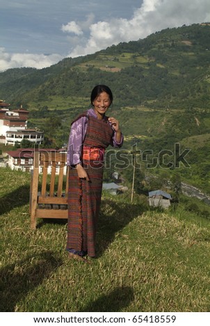 RANGJUNG, BHUTAN - SEPTEMBER 29: unidentified woman shows her traditional dress named Kira in front of the Rangjung Monastery on September 28, 2007 in Rangjung, Bhutan