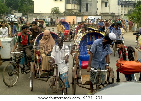 DHAKA, BANGLADESH - SEPTEMBER 17, Unidentified people travel in the rush hour with rickshaws and bicycles on September 17, 2007 in Dhaka, Bangladesh