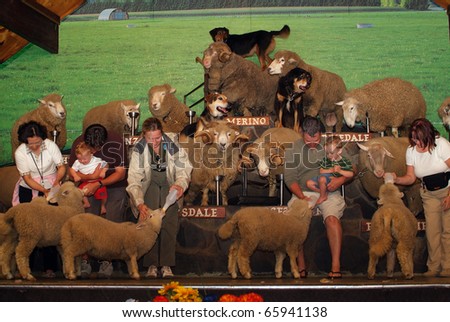 SOUTH ISLAND, NEW ZEALAND - MARCH 11: Unidentified people with sheep are on stage during an exhibition in Agrodome on March 11, 2005 in Agrodome, New Zealand
