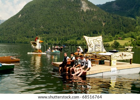 BAD AUSSEE, AUSTRIA - MAY 30: unidentified people on boat with flower-decorated sculpture by Festival of Narcissus on the Grundlsee(Lake) on May 30, 2005 in Bad Aussee in Styria, Austria