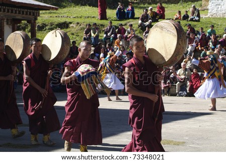 HAA, BHUTAN - SEPTEMBER 21: unidentified monks in their traditional red dress with drums perform a sacred ceremony called Tshechu at the Karpho Temple on September 21, 2007 in Haa Village, Bhutan