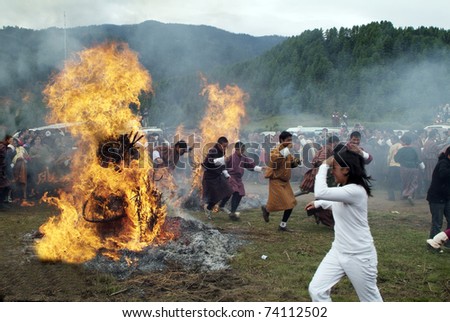 JAKAR, BUMTHANG, BHUTAN - SEPTEMBER 26: unidentified people running through an open fire at the fire and smoke ceremony in Thangbi Lakhang on September 26, 2007 in Jakar, Bhutan