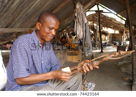 UNKNOWN VILLAGE IN KENYA - FEBRUARY 01: unidentified inhabitant in a small factory produce typical african souvenirs without mechanical equipment on February 01, 2011 in a village in Kenya, Africa
