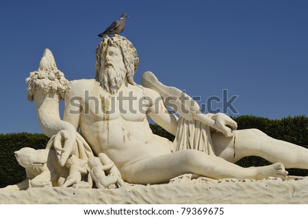 Paris, France, sculpture with pigeon on top in the garden of the uileries