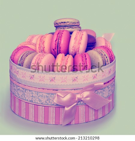 Colorful french macaroons, traditional Parisian cookie.  Sweet background with retro vintage instagram filter