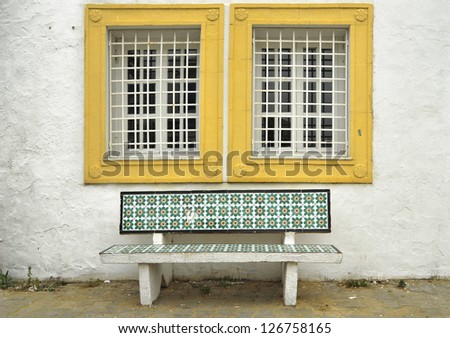 Traditional Tunisian bench under a window