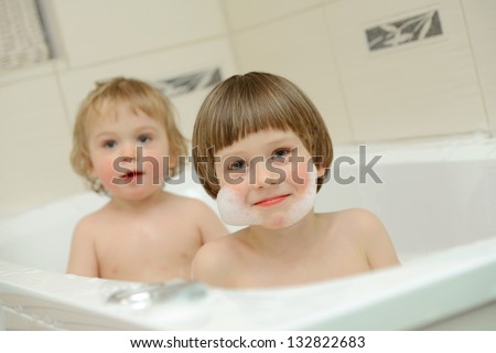 Two cute little boys having a bath together