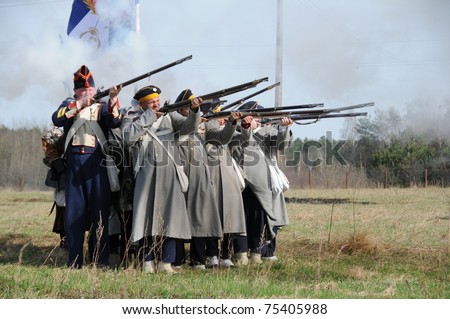 IGANIE, POLAND - APRIL 16: Members of 2nd Infantry Regiment of Duchy of Warsaw fire rifles at Battle of Iganie (1831) reenacted on battlefield on 180th anniversary on April 16, 2011 in Iganie, Poland