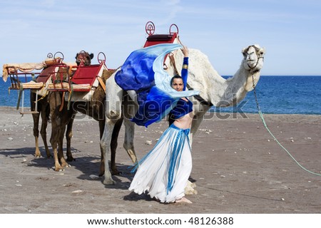 Belly Dancer next to a Camel Train
