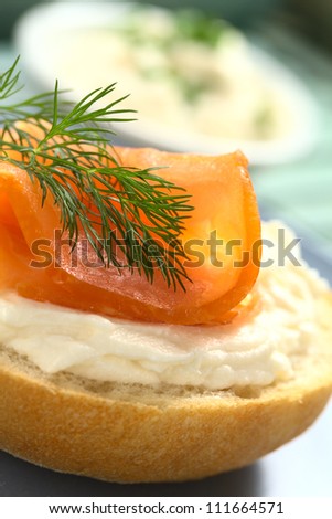 Smoked salmon and cream cheese canape garnished with dill (Selective Focus, Focus on the front of the dill)