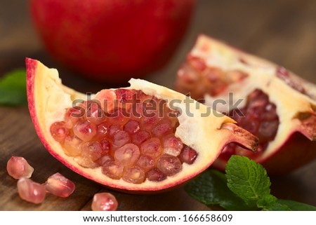Open pomegranate fruit (lat. Punica granatum) with seeds (Selective Focus, Focus on the lower seeds)