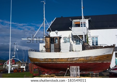 LOFOTEN, NORWAY - JULY 13, 2008: Wooden fishing boat on land on July 13, 2008 on the Lofoten in Norway. The Lofoten is an island group in Northern Norway and lives mainly from fishing and tourism.