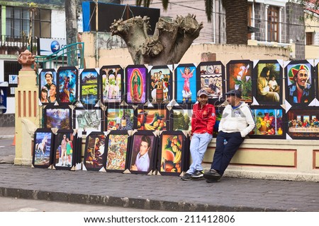 BANOS, ECUADOR - FEBRUARY 22, 2014: Unidentified people selling paintings outside the park Palomino Flores on Ambato Street on February 22, 2014 in Banos, Ecuador.