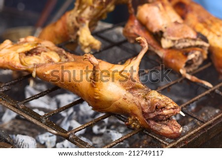 BANOS, ECUADOR - FEBRUARY 28, 2014: Roasted guinea pigs on Ambato Street at the market hall on February 28, 2014 in Banos, Ecuador. In Ecuador, guinea pig (or cuy in Spanish) is considered a delicacy.