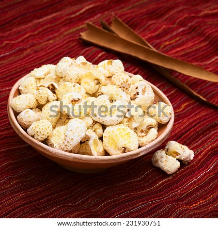 Sweetened popped white corn called Pasancalla eaten as snack in Bolivia served in a clay bowl, photographed with natural light (Selective Focus, Focus on the first part of the snack)