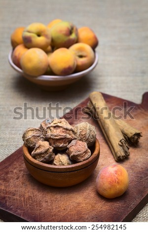 Dried peeled peach quisa (also kisa, mocochinchi) from which a beverage is prepared with sugar and cinnamon in Bolivia (Photographed with natural light) (Selective Focus, Focus on the front peaches)