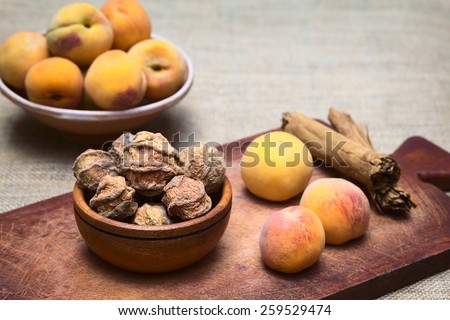 Dried peeled peach called quisa, kisa, mocochinchi from which a beverage is prepared with sugar and cinnamon in Bolivia, photographed with natural light (Selective Focus, Focus on the front peaches)