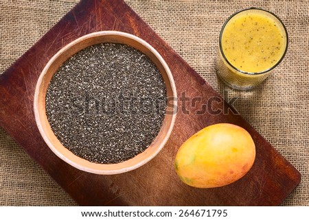 Overhead shot of chia seed (lat. Salvia hispanica) in bowl with mango and mango-chia juice photographed with natural light. Chia is considered a superfood with protein, omega fat, mineral, antioxidant