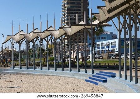 IQUIQUE, CHILE - FEBRUARY 10, 2015: Partly shaded sitting area along the Pacific coast on February 10, 2015 in Iquique, Chile. Iquique is a popular beach town and free port city in Northern Chile.