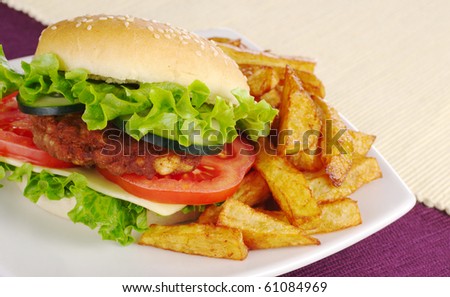 Hamburger with French fries on purple and white place mats (Selective focus)