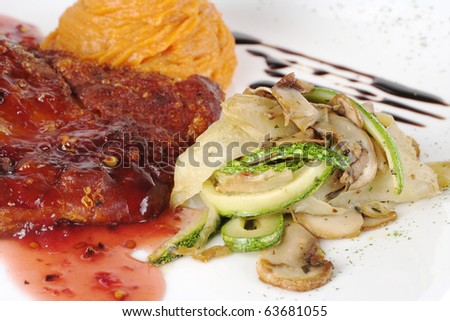 Rib with red sauce, vegetables and sweet potato puree (Selective Focus, Focus on front of the meat and the vegetable pile)
