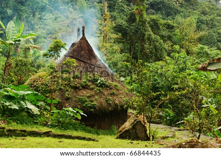 Small kogi hut built in the traditional way of the Tayrona in Northern Colombia. The roof of the hut has to be kept dry as it rains every day in this region, thus the smoke coming through the roof.