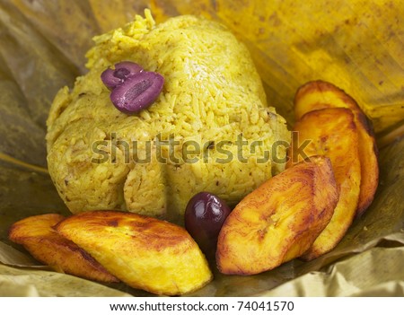 Traditional Peruvian food called Juane from the jungle area. This meal consists of rice, meat, eggs and black olives and is wrapped in bijao leave. It\'s accompanied by fried plantains and black olives