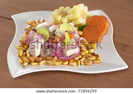 Peruvian-style ceviche from raw mahi-mahi fish (Spanish: perico), red onions, limes and aji (Peruvian hot pepper) and served with roasted corn (cancha), cooked corn, sweet potato (Selective Focus)