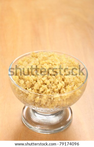 Cooked white quinoa in glass bowl which can be eaten as a side dish like rice and is rich in proteins (Selective Focus, Focus on the front of the quinoa)